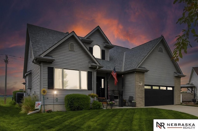 13410 Highlander Pl, Waverly, NE 68462 - view of front of house with concrete driveway, a lawn, and roof with shingles