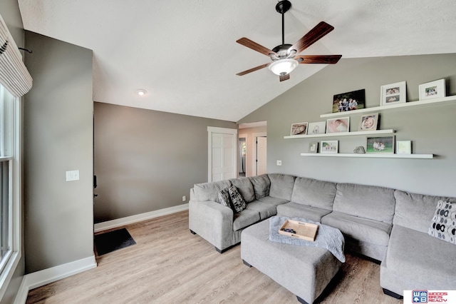 631 Overlook Ln, Beatrice, NE 68310 - living area featuring lofted ceiling, a ceiling fan, light wood-style flooring, and baseboards