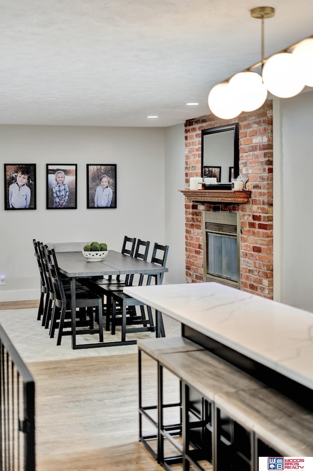 631 Overlook Ln, Beatrice, NE 68310 - dining area featuring light wood finished floors, a fireplace, and baseboards