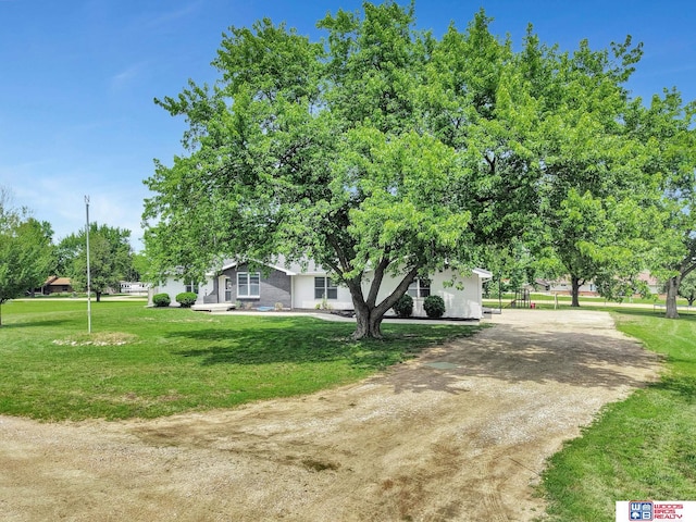 631 Overlook Ln, Beatrice, NE 68310 - view of green lawn featuring dirt driveway