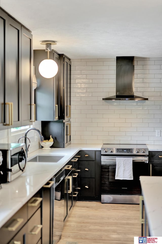 631 Overlook Ln, Beatrice, NE 68310 - kitchen featuring stainless steel range with electric cooktop, wall chimney exhaust hood, a sink, tasteful backsplash, and light wood finished floors
