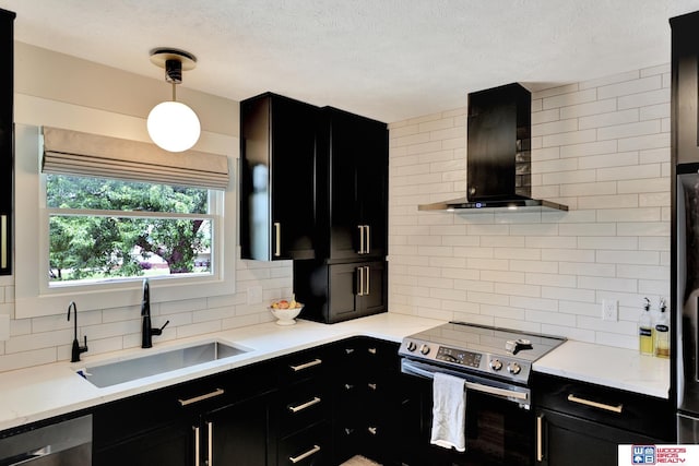 631 Overlook Ln, Beatrice, NE 68310 - kitchen with dark cabinetry, appliances with stainless steel finishes, a sink, wall chimney exhaust hood, and tasteful backsplash