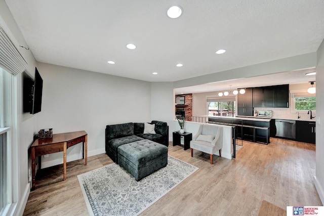 631 Overlook Ln, Beatrice, NE 68310 - living area with light wood-style floors, healthy amount of natural light, recessed lighting, and baseboards