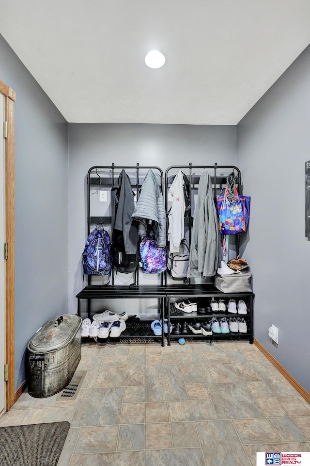 631 Overlook Ln, Beatrice, NE 68310 - mudroom featuring baseboards and stone finish flooring
