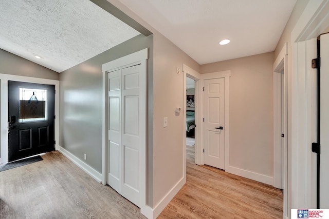 631 Overlook Ln, Beatrice, NE 68310 - foyer with light wood finished floors, baseboards, lofted ceiling, and recessed lighting
