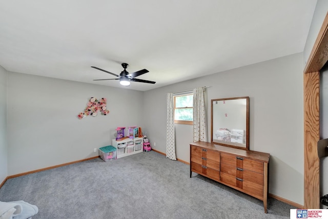 631 Overlook Ln, Beatrice, NE 68310 - rec room with ceiling fan, light carpet, and baseboards