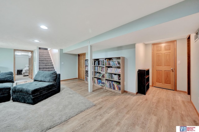 631 Overlook Ln, Beatrice, NE 68310 - living area with wood finished floors, baseboards, stairway, and recessed lighting