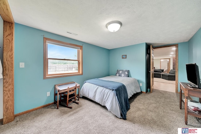 631 Overlook Ln, Beatrice, NE 68310 - carpeted bedroom with baseboards and a textured ceiling