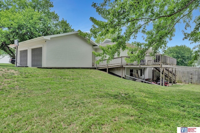 631 Overlook Ln, Beatrice, NE 68310 - view of grassy yard featuring a wooden deck, stairway, and a detached garage