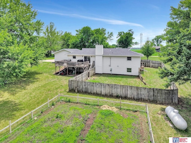 631 Overlook Ln, Beatrice, NE 68310 - rear view of property featuring a wooden deck, a chimney, and stairway