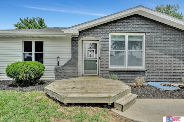 631 Overlook Ln, Beatrice, NE 68310 - entrance to property with a wooden deck and brick siding