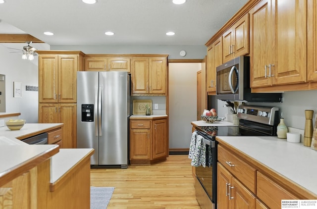 2442 E 2nd St, Fremont, NE 68025 - kitchen with appliances with stainless steel finishes, ceiling fan, light countertops, light wood-type flooring, and recessed lighting