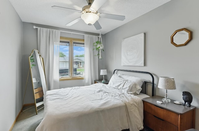 2442 E 2nd St, Fremont, NE 68025 - bedroom featuring carpet floors, baseboards, a ceiling fan, and a textured ceiling