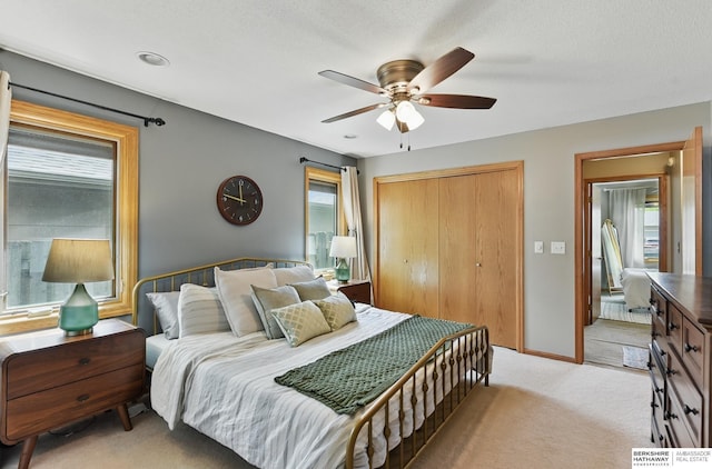 2442 E 2nd St, Fremont, NE 68025 - bedroom with a closet, light colored carpet, and a ceiling fan