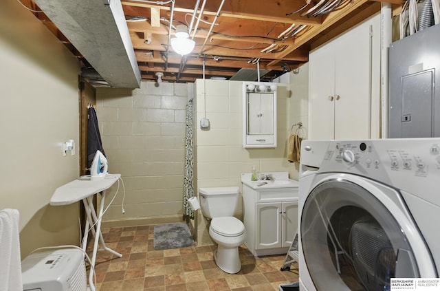 2442 E 2nd St, Fremont, NE 68025 - laundry area featuring washer / dryer, electric panel, and concrete block wall