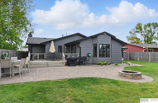2442 E 2nd St, Fremont, NE 68025 - rear view of property with a fire pit and a patio