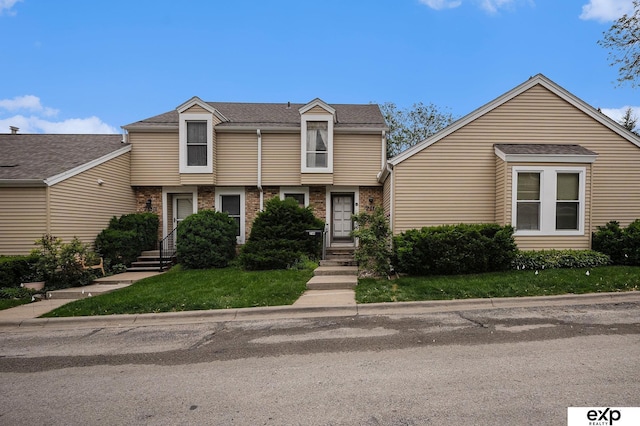 719 N 130th Plz Unit A-11, Omaha, NE 68154 - townhome / multi-family property with a front lawn and brick siding