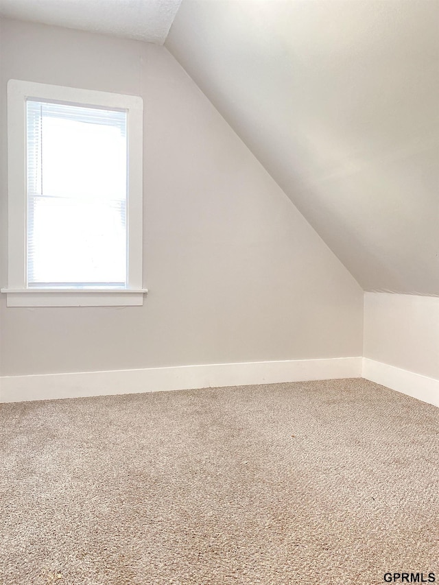 3719 X St, Omaha, NE 68107 - additional living space featuring lofted ceiling, carpet floors, and baseboards