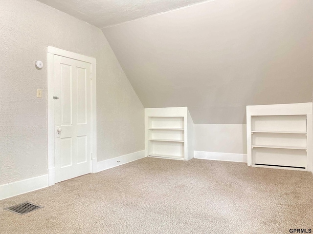 3719 X St, Omaha, NE 68107 - bonus room with carpet, lofted ceiling, built in shelves, and baseboards