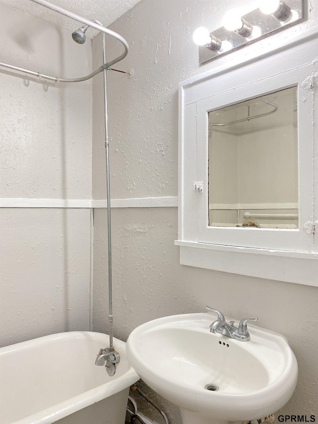 3719 X St, Omaha, NE 68107 - full bath featuring a freestanding bath, a sink, and a textured wall