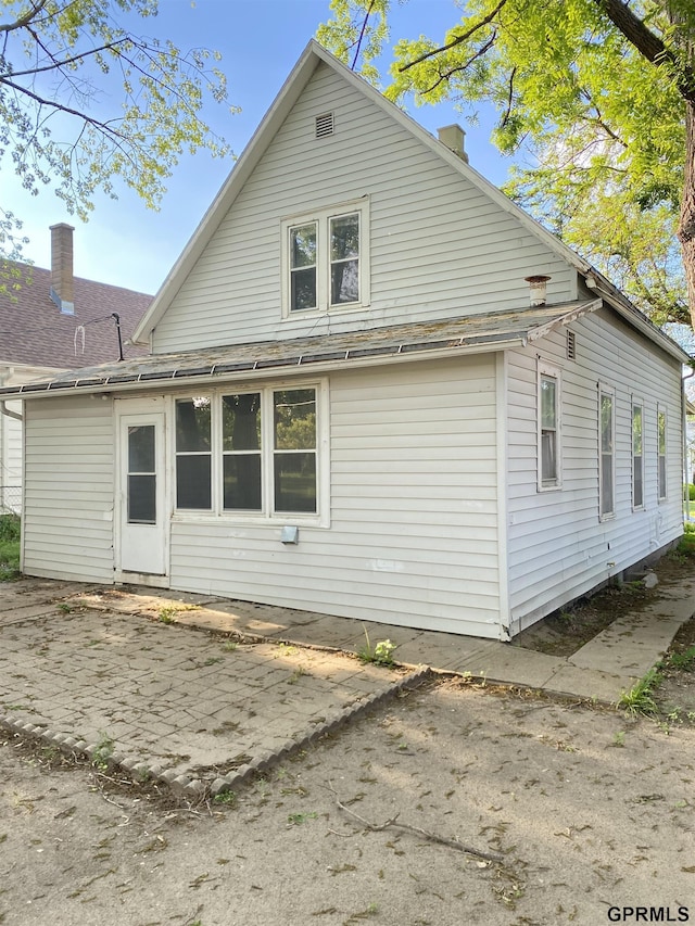 3719 X St, Omaha, NE 68107 - back of property with roof with shingles and a patio