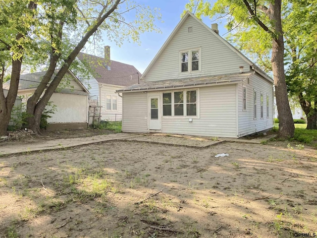 3719 X St, Omaha, NE 68107 - rear view of property with a chimney
