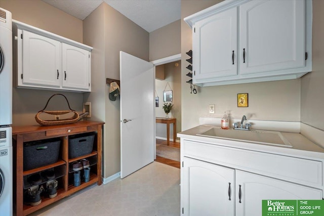 802 N Fillmore St, Papillion, NE 68046 - laundry room with a sink and stacked washer and clothes dryer