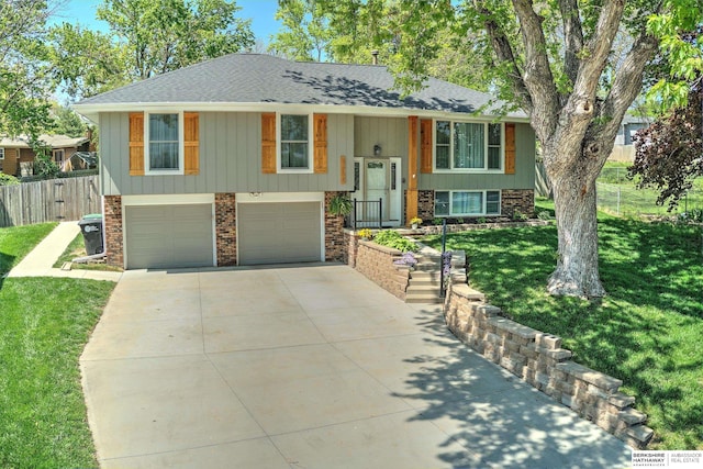 3256 S 130th Cir, Omaha, NE 68144 - bi-level home featuring a shingled roof, an attached garage, concrete driveway, and brick siding