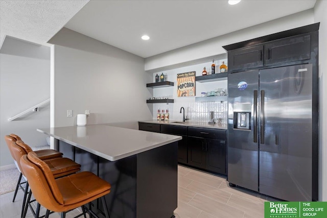 6518 S 208th Ave, Elkhorn, NE 68022 - indoor wet bar featuring stainless steel refrigerator with ice dispenser, recessed lighting, and tasteful backsplash