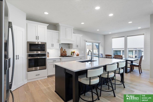 6518 S 208th Ave, Elkhorn, NE 68022 - kitchen with oven, a sink, fridge, tasteful backsplash, and light wood-style floors