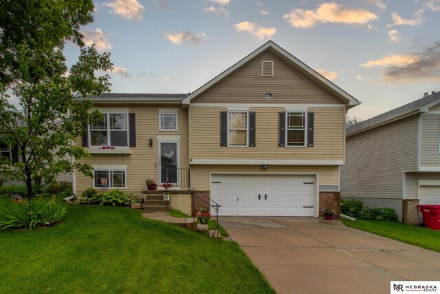 15417 Willit St, Bennington, NE 68007 - raised ranch featuring an attached garage, a front lawn, driveway, and brick siding