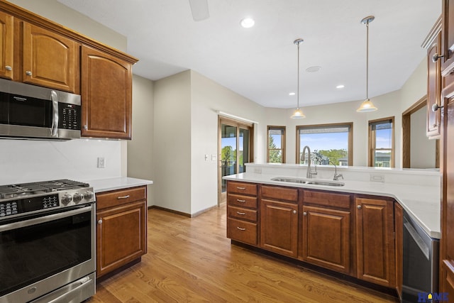 6920 NW 3rd St, Lincoln, NE 68521 - kitchen with appliances with stainless steel finishes, a sink, healthy amount of natural light, light wood-style floors, and recessed lighting