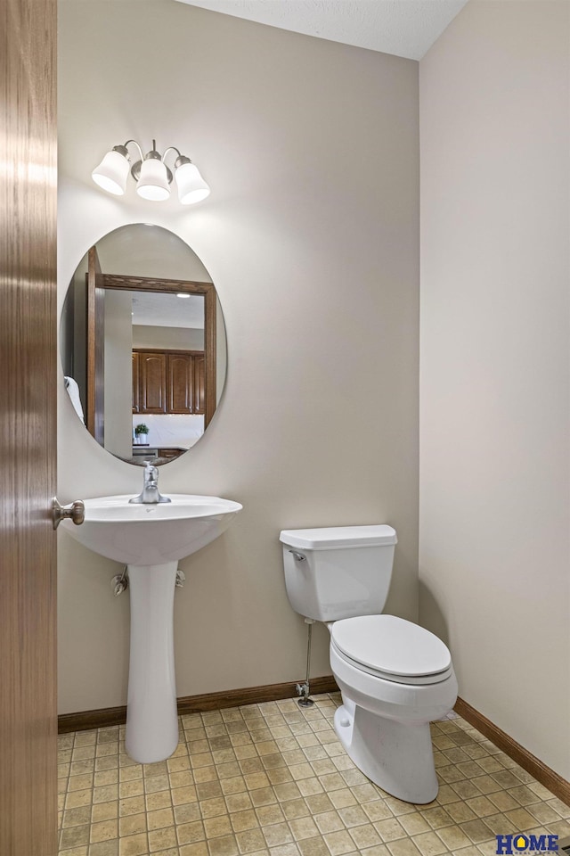 6920 NW 3rd St, Lincoln, NE 68521 - half bathroom featuring toilet, baseboards, and tile patterned flooring