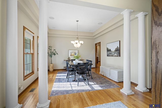 6920 NW 3rd St, Lincoln, NE 68521 - dining space with wood finished floors, ornate columns, plenty of natural light, and a chandelier