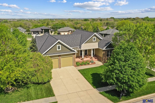 6920 NW 3rd St, Lincoln, NE 68521 - traditional-style house featuring brick siding, driveway, an attached garage, covered porch, and a shingled roof