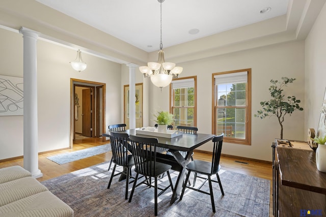 6920 NW 3rd St, Lincoln, NE 68521 - dining room with decorative columns, light wood finished floors, baseboards, and a chandelier