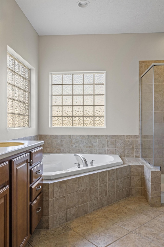 6920 NW 3rd St, Lincoln, NE 68521 - bathroom with a garden tub, vanity, a stall shower, and tile patterned flooring