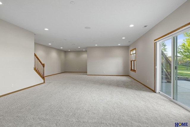 6920 NW 3rd St, Lincoln, NE 68521 - empty room featuring light colored carpet, baseboards, recessed lighting, and stairs
