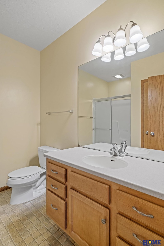 6920 NW 3rd St, Lincoln, NE 68521 - bathroom featuring vanity, toilet, a stall shower, and tile patterned floors