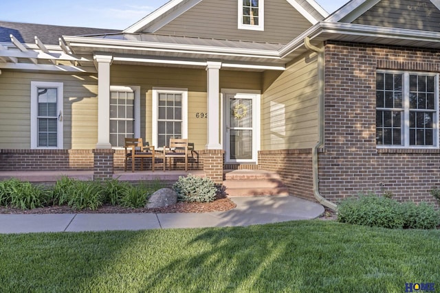 6920 NW 3rd St, Lincoln, NE 68521 - entrance to property with a porch, brick siding, and a lawn