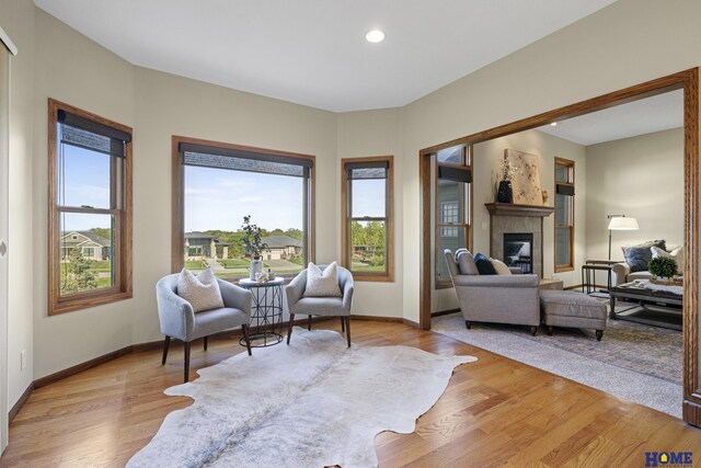 6920 NW 3rd St, Lincoln, NE 68521 - sitting room featuring a tile fireplace, light wood-style floors, baseboards, and recessed lighting