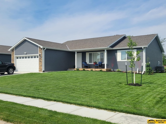 843 N 26th St, Beatrice, NE 68310 - ranch-style home featuring a porch, an attached garage, a front lawn, concrete driveway, and roof with shingles
