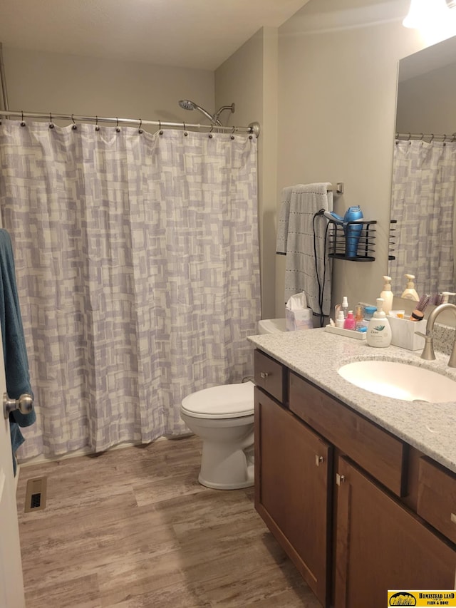 843 N 26th St, Beatrice, NE 68310 - full bathroom featuring wood finished floors and vanity