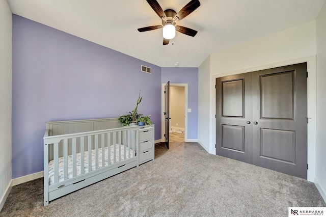 905 Chicory Ln, Hickman, NE 68372 - carpeted bedroom featuring baseboards, a closet, a crib, and a ceiling fan