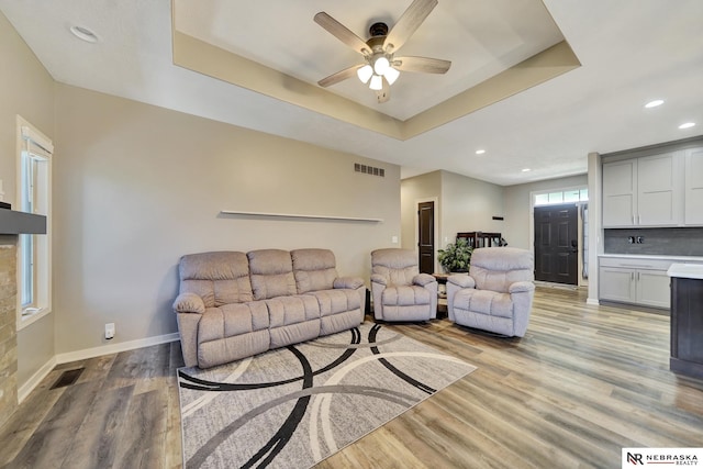 905 Chicory Ln, Hickman, NE 68372 - living area featuring a tray ceiling, light wood finished floors, a ceiling fan, recessed lighting, and baseboards