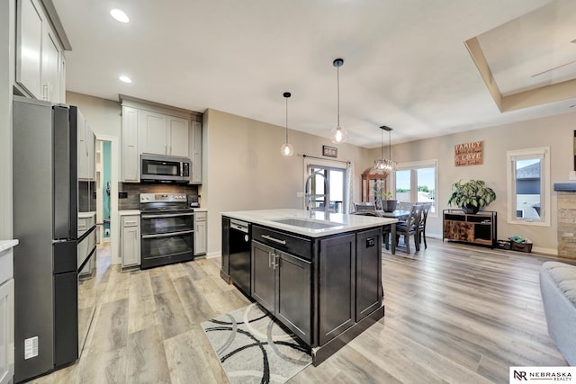 905 Chicory Ln, Hickman, NE 68372 - kitchen with range with two ovens, stainless steel microwave, freestanding refrigerator, dishwasher, and a sink