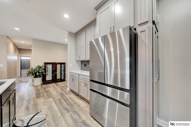 905 Chicory Ln, Hickman, NE 68372 - kitchen with freestanding refrigerator, light countertops, light wood finished floors, recessed lighting, and gray cabinets