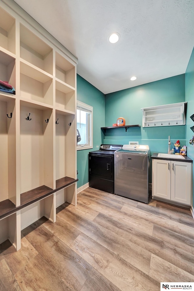 905 Chicory Ln, Hickman, NE 68372 - laundry room with washing machine and dryer, light wood-type flooring, cabinet space, recessed lighting, and baseboards