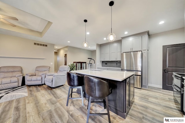 905 Chicory Ln, Hickman, NE 68372 - kitchen featuring freestanding refrigerator, a sink, light countertops, light wood-style flooring, and open floor plan