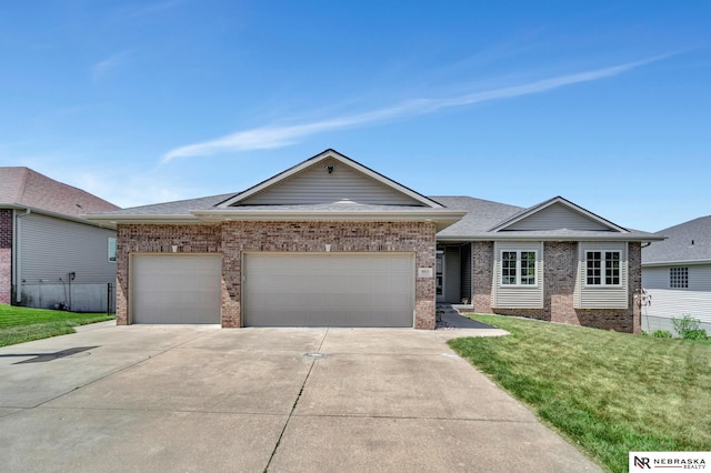 905 Chicory Ln, Hickman, NE 68372 - single story home featuring brick siding, concrete driveway, an attached garage, and a front lawn